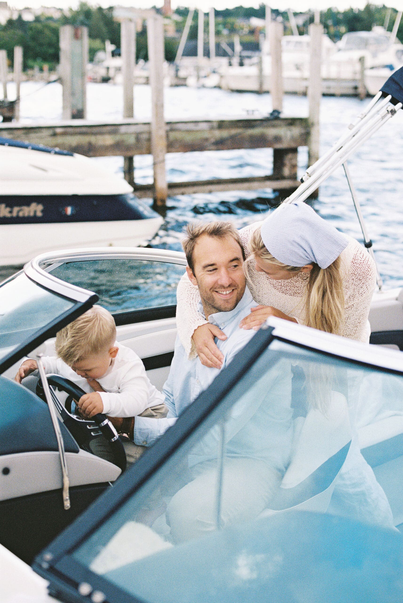 candid moment between a family of three on their boat during a family session